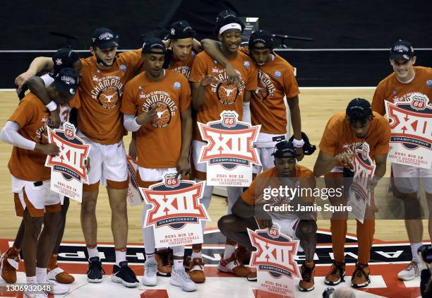 The Texas Longhorns celebrate after defeating the Oklahoma State Cowboys 91-86 to win the Big 12 Basketball Tournament championship game at the...