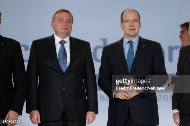 Prince Albert II of Monaco and Dimitri Pachomov pose for pictures during the flag ceremony for Sochi olympic games 2014 at the Peace & Sport 5th...