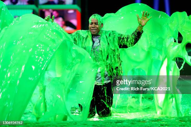 In this image released on March 13, Host Kenan Thompson gets slimed onstage during Nickelodeon's Kids' Choice Awards at Barker Hangar on March 13,...