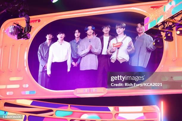 In this image released on March 13, V, Suga, Jin, Jungkook, RM, Jimin, and J-Hope of BTS, winner of Favorite Music Group, are seen on screen during...