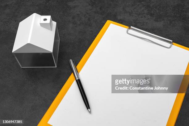 mini model house and clipboard on work desk - pen mockup stock pictures, royalty-free photos & images