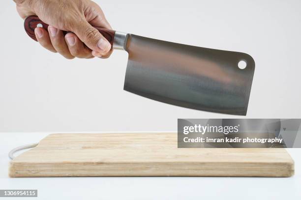 holding butcher on empty wooden chopper - butcher knife stock-fotos und bilder