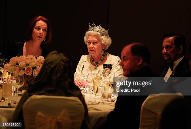 Queen Elizabeth II sits beside Australia's Prime Minister Julia Gillard during a banquet at the Pan Pacific Perth Hotel as part of the Commonwealth...