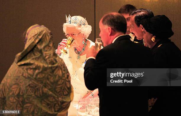 Queen Elizabeth II and guests drink a toast during banquet at the Pan Pacific Hotel Perth as part of the Commonwealth Heads of Government Meeting on...