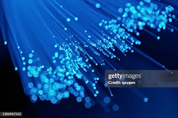 abstract fiber optics blue on black background - fibra fotografías e imágenes de stock