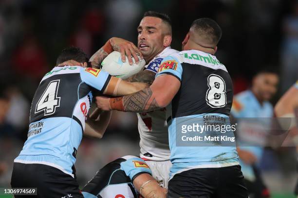 Paul Vaughan of the Dragons is tackled during the round one NRL match between the St George Illawarra Dragons and the Cronulla Sharks at Netstrata...