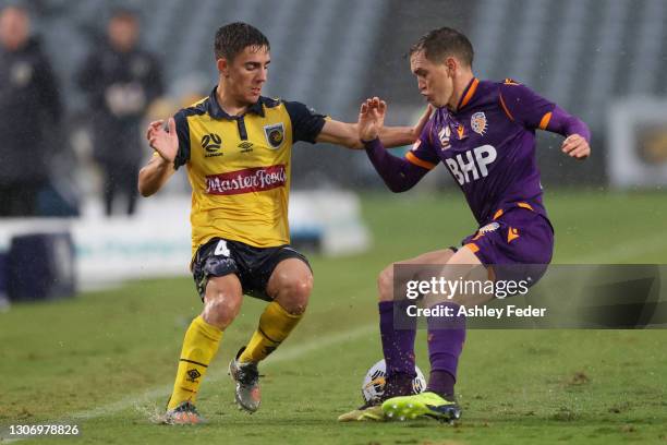 Joshua Nisbet of the Mariners contests the ball against Neil Kilkenny of Perth Glory during the A-League match between the Central Coast Mariners and...