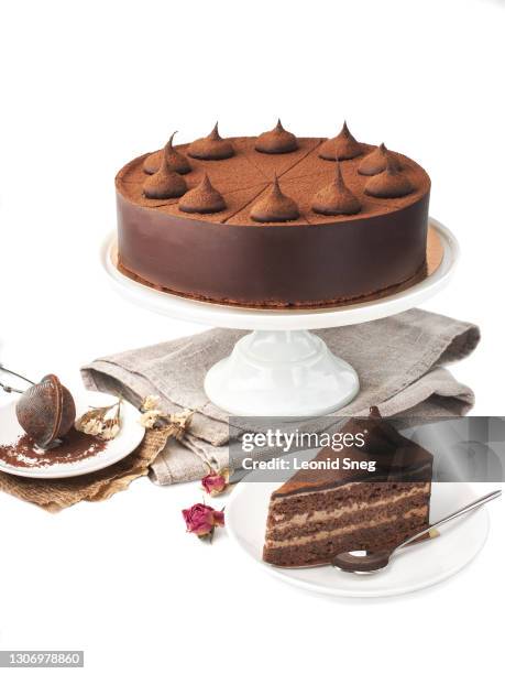 food photography of homemade chocolate truffle cake side view on a ceramic stand, on white background isolated - cocoa powder stock pictures, royalty-free photos & images