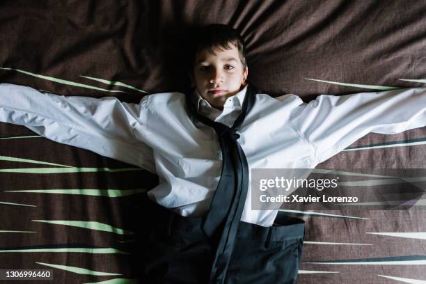 portrait of a little boy wearing adult clothes - oversized object stock pictures, royalty-free photos & images