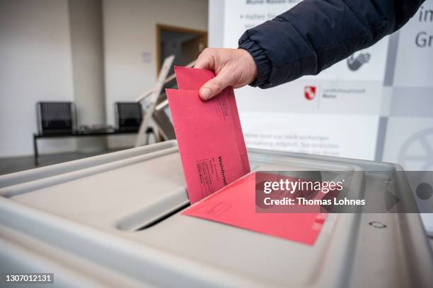 Man casts his postal vote in the state elections in Rhineland-Palatinate during the coronavirus pandemic on March 14, 2021 in Mainz, Germany. Voters...