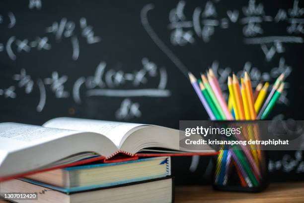 educaeducation concept,back to school supplies. books and blackboard on wooden background,educationtion concept - text book stockfoto's en -beelden