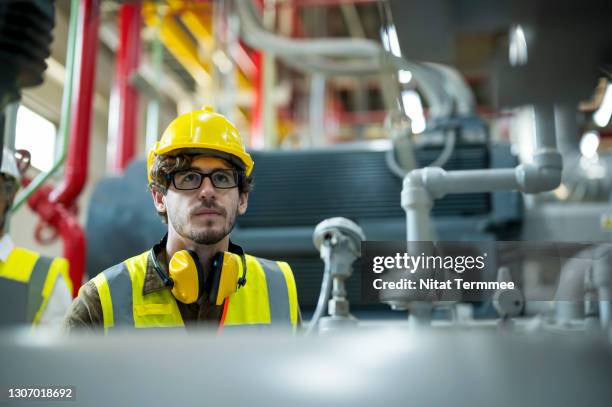 boiler inspection and maintenance. industrial engineer checking on pipes, valve and boiler pressure in control room of food processing plant. monitoring, surveillance and conduct safety inspection. - manufacturing equipment photos et images de collection