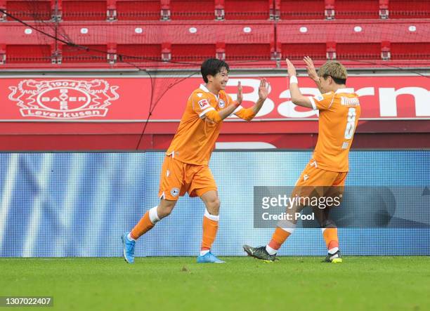 Masaya Okugawa of DSC Arminia Bielefeld celebrates with team mate Ritsu Doan after scoring their side's second goal during the Bundesliga match...