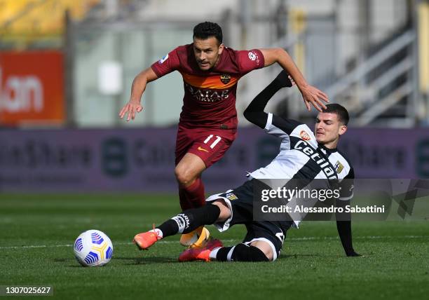 Pedro of A.S Roma is challenged by Valentin Mihaila of Parma Calcio 1913 during the Serie A match between Parma Calcio and AS Roma at Stadio Ennio...