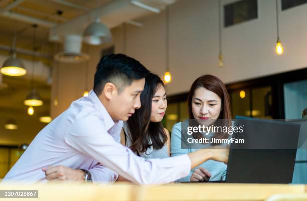 asians millennials discussing work in coworking space. - southeast stock pictures, royalty-free photos & images