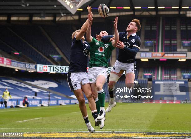 Keith Earls of Ireland competes for the ball with Chris Harris and Stuart Hogg of Scotland leading to the first try scored by Robbie Henshaw during...
