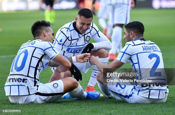 Lautaro Martinez of Internazionale celebrates with team mates Alexis Sanchez and Achraf Hakimi after scoring their side's second goal during the...