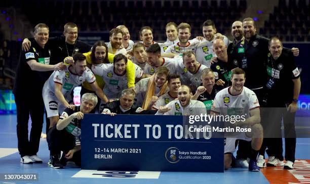 The team of Germany pose with the ticket to Tokyo after beating Algerina during the IHF Tokyo Handball Qualification match between Algeria and...