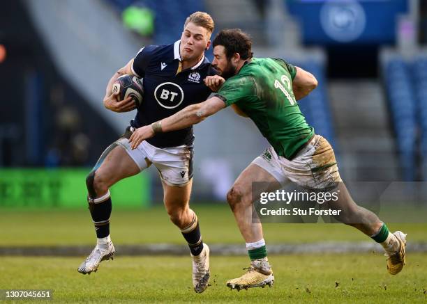 Duhan van der Merwe of Scotland is held back by Robbie Henshaw of Ireland during the Guinness Six Nations match between Scotland and Ireland at...