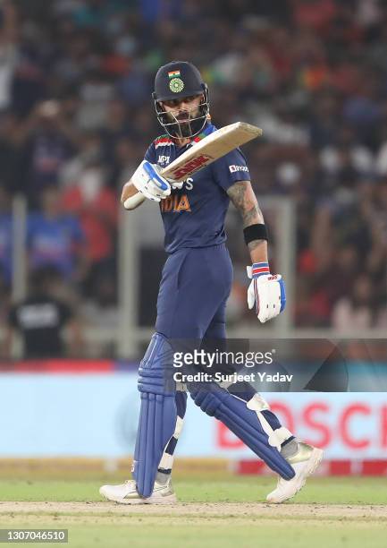 Virat Kohli of India celebrates after reaching their half century during the 2nd T20 International match between India and England at Narendra Modi...