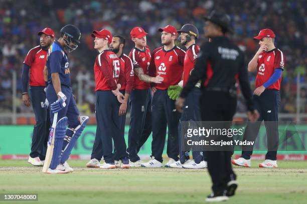 The England side watch the big screen for a third umpire review for the stumping of Virat Kohli of India during the 2nd T20 International match...