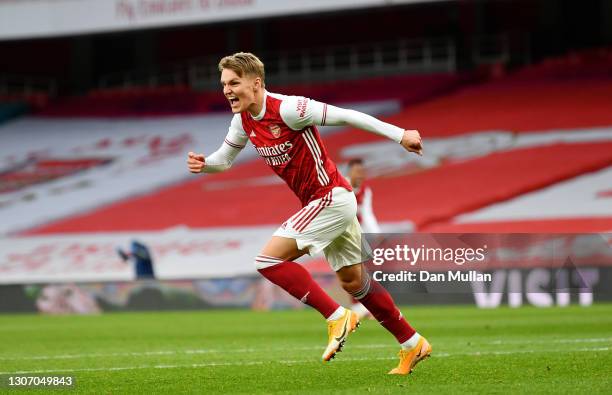 Martin Odegaard of Arsenal celebrates after scoring their side's first goal during the Premier League match between Arsenal and Tottenham Hotspur at...