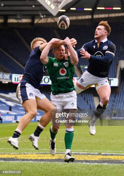 Keith Earls of Ireland competes for the ball with Chris Harris and Stuart Hogg of Scotland leading to the first try scored by Robbie Henshaw during...