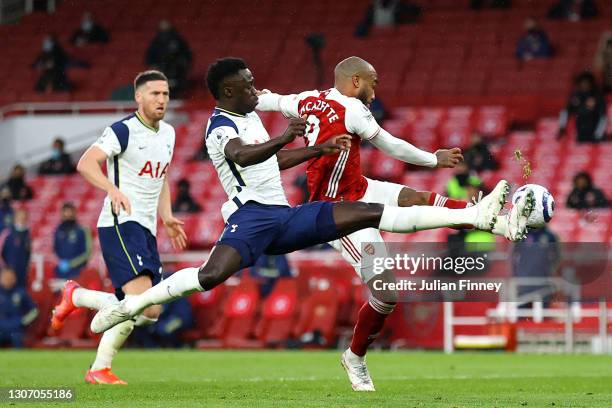 Alexandre Lacazette of Arsenal is challenged by Davinson Sanchez of Tottenham Hotspur leading to a penalty being awarded during the Premier League...