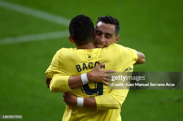 Carlos Bacca of Villarreal CF celebrates with Ramiro Funes Mori after scoring their side's second goal during the La Liga Santander match between SD...