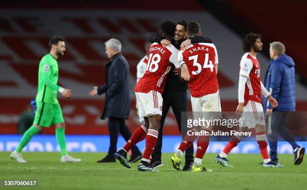 Mikel Arteta, Manager of Arsenal celebrates victory with Thomas Partey and Granit Xhaka of Arsenal following the Premier League match between Arsenal...
