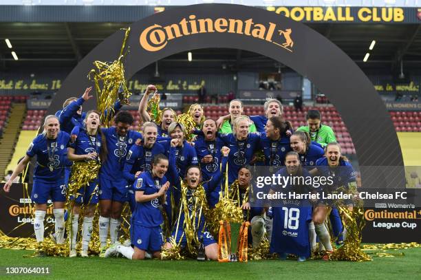 Chelsea players celebrate with the FA Women's Continental Tyres League Cup Trophy following their team's victory in the FA Women's Continental Tyres...