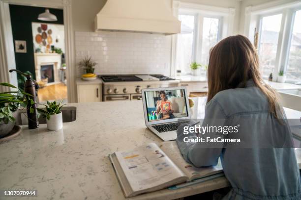 elementary student on video call with her teacher at home - teaching remotely stock pictures, royalty-free photos & images