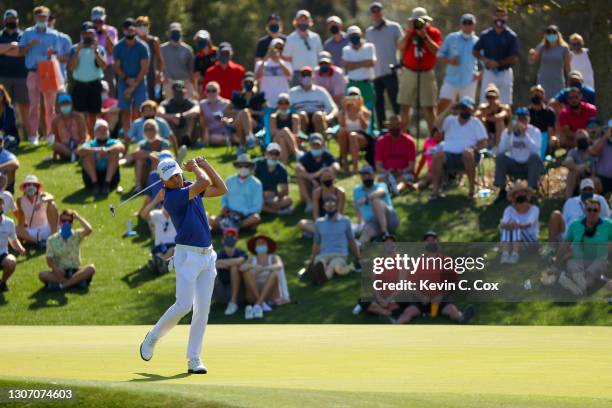 Justin Thomas of the United States reacts to his eagle putt on the 11th green during the final round of THE PLAYERS Championship on THE PLAYERS...