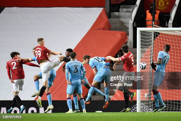 Craig Dawson of West Ham United scores an own goal for Manchester United's first goal whilst under pressure from Scott McTominay of Manchester United...