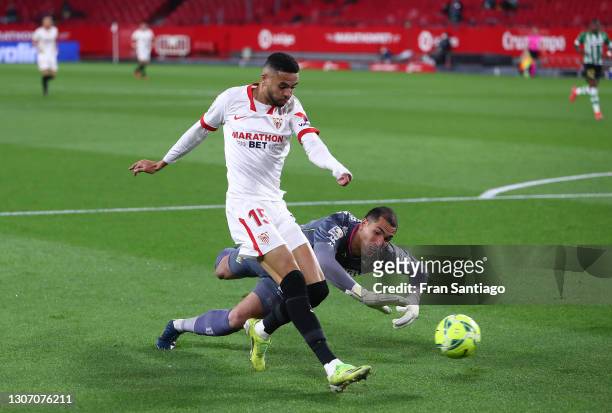 Yousseff En-Nesyri of Sevilla scores their side's first goal as he is challenged by Joel Robles of Real Betis during the La Liga Santander match...