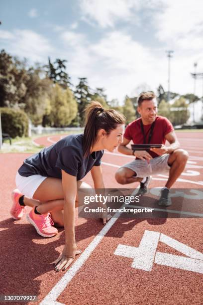 coach with runner on the track - sports performance stock pictures, royalty-free photos & images