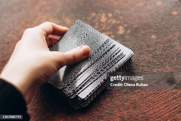 woman's hand holding a deck of cards - dela ut kort bildbanksfoton och bilder