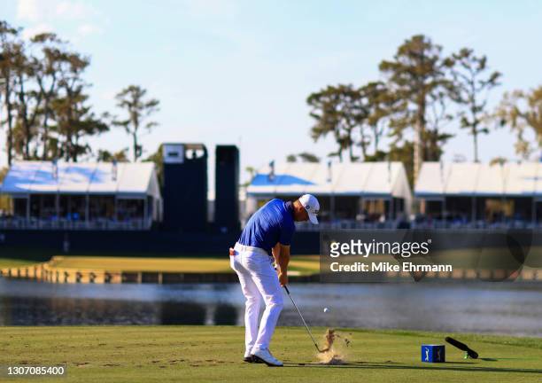 Justin Thomas of the United States plays his shot from the 17th tee during the final round of THE PLAYERS Championship on THE PLAYERS Stadium Course...