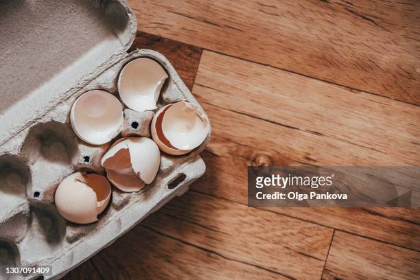 eggshells in paper packaging on wooden background. separate waste collection, zero waste, recycling, reuse. - eggshell stock pictures, royalty-free photos & images