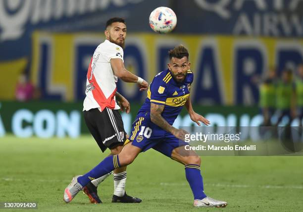 Carlos Tevez of Boca Juniors fights for the ball with Paulo Díaz of River Plate during a match between Boca Juniors and River Plate as part of Copa...
