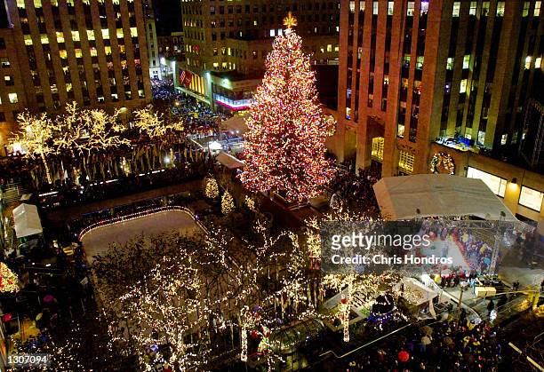 The Rockefeller Center Christmas tree lights up the Plaza at the annual lighting ceremony in New York City, November 29, 2000. Thousands of people...
