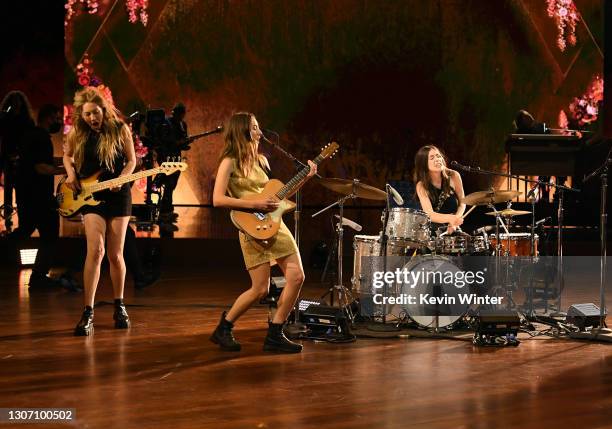 In this image released on March 14, Este Haim, Alana Haim, and Daneille Haim of HAIM perform onstage during the 63rd Annual GRAMMY Awards at Los...