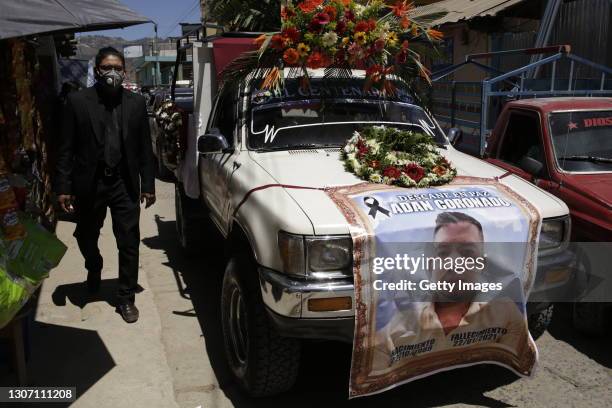 Car shows the image of Adam Coronado prior to his departure to the cemetery on March 14, 2021 in Comitancillo, Guatemala. 19 shot and charred bodies...