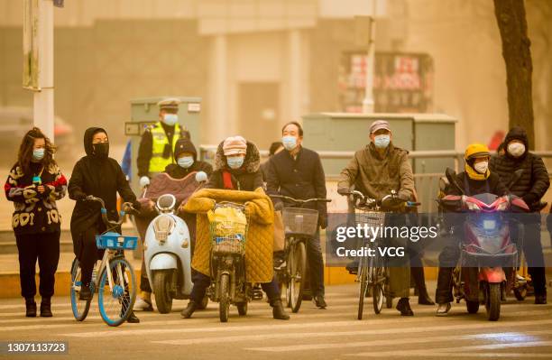 Citizens ride motorbikes in sandstorm on March 15, 2021 in Hohhot, Inner Mongolia Autonomous Region of China. Sandstorm blankets parts of regions in...