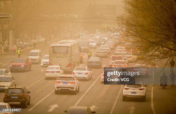 Vehicles move in sandstorm on March 15, 2021 in Hohhot, Inner Mongolia Autonomous Region of China. Sandstorm blankets parts of regions in north China...