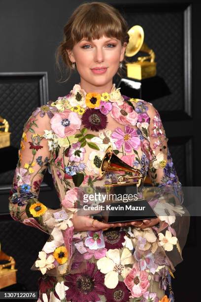 Taylor Swift, winner of the Album of the Year award for ‘Folklore,’ poses in the media room during the 63rd Annual GRAMMY Awards at Los Angeles...