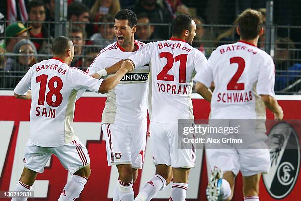 Michael Ballack of Leverkusen celebrates his team's first goal with team mates Sidney Sam, Oemer Toprak and Daniel Schwaab during the Bundesliga...