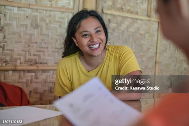 malaysian woman having a job interview for a non-profit environmental organization - casual job interview stock pictures, royalty-free photos & images