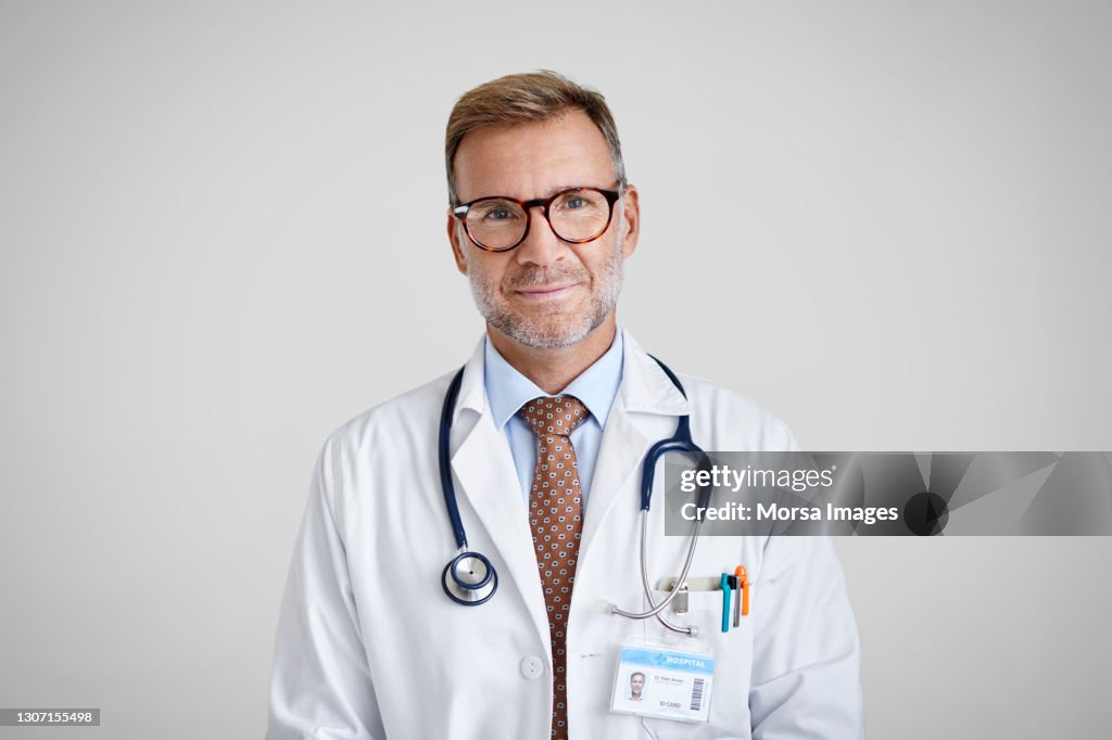 Doctor High Resolution Smiling Male Doctor Against Gray Background High-Res Stock Photo ...