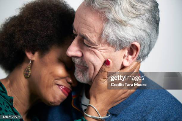 mature couple embracing - romantic couple on white background stock-fotos und bilder